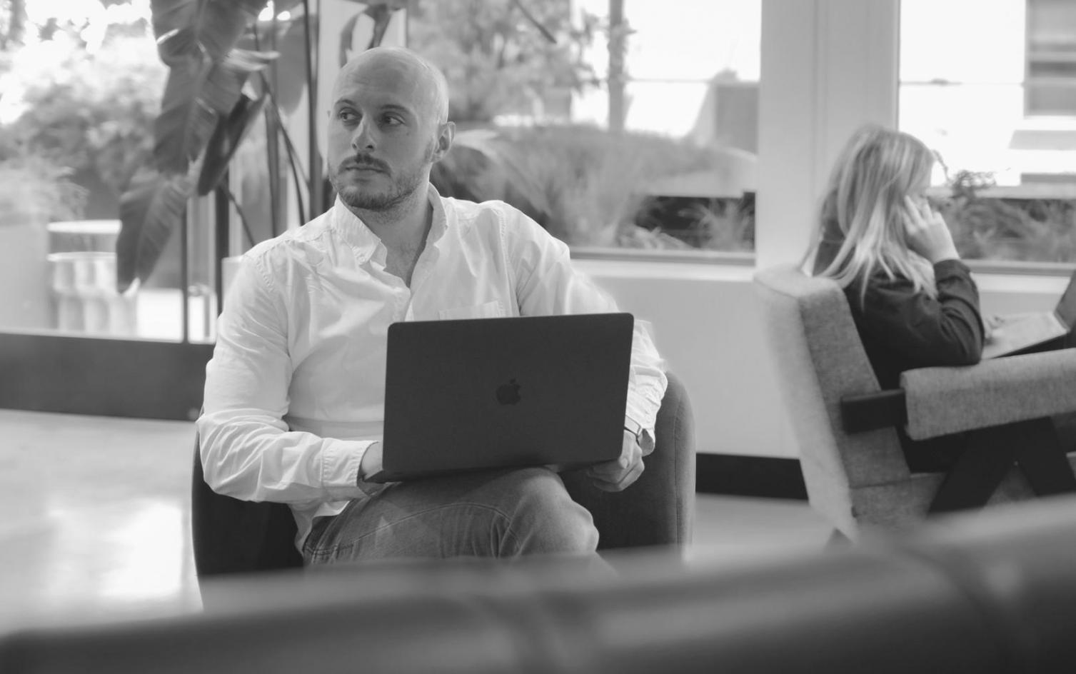 Team collaboration around table with financial documents and digital devices showing data analysis