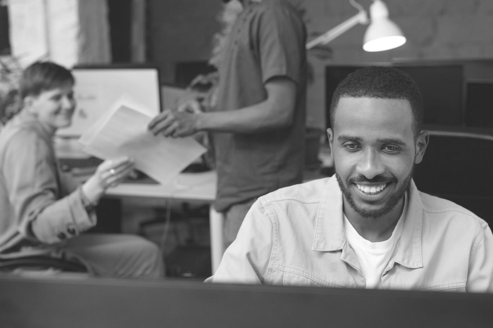 Business professional analyzing financial reports on laptop with charts and graphs displayed